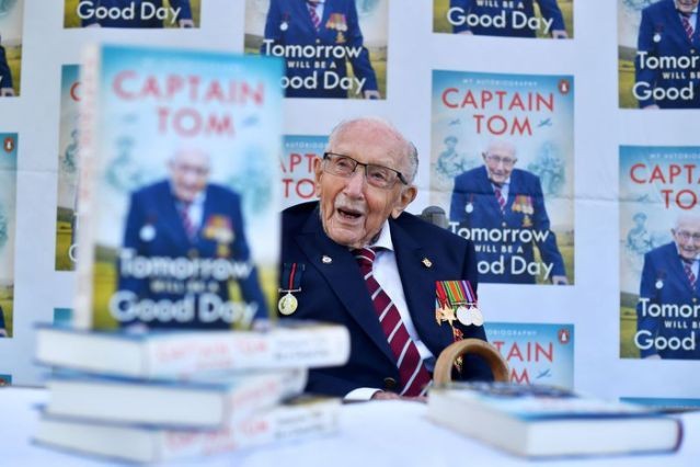 FILE PHOTO: Captain Sir Tom Moore smiles as he launches his autobiography book 'Tomorrow will be a Good Day' at his home in Milton Keynes, Britain September 17, 2020. REUTERS/Dylan Martinez/File Photo